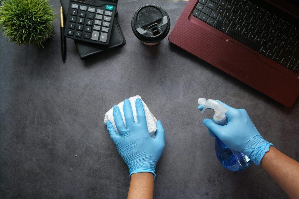 Office cleaning service with gloves and cleaning spray